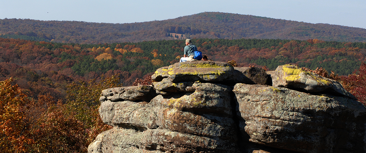 hiker sitting on rock formation in Carbondale